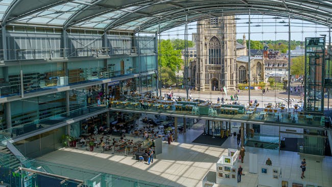 A view looking down on The Forum, Norwich. A modern landmark building with glass frontage looking out to St Peter Mancroft Church.