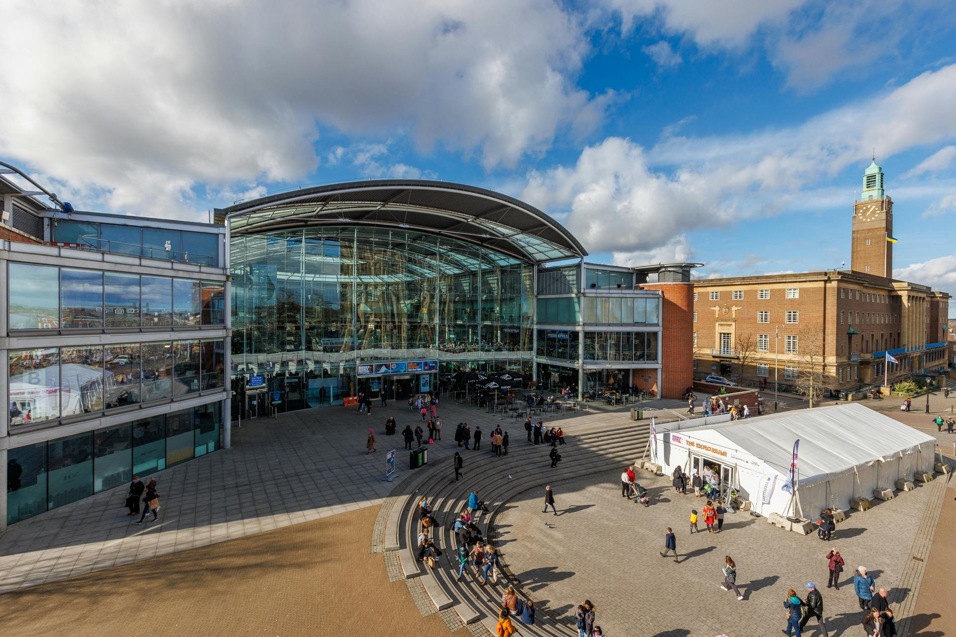 The Forum, a large glass building on a bright sunny day.