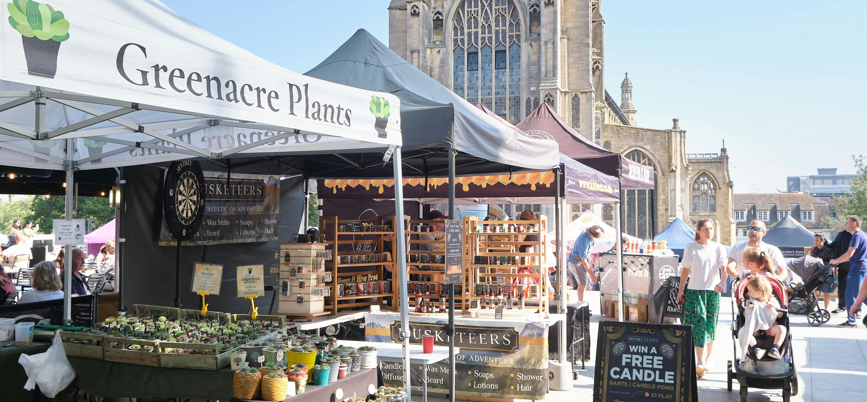 Market stalls outside The Forum in Norwich selling plants, soaps and rum.