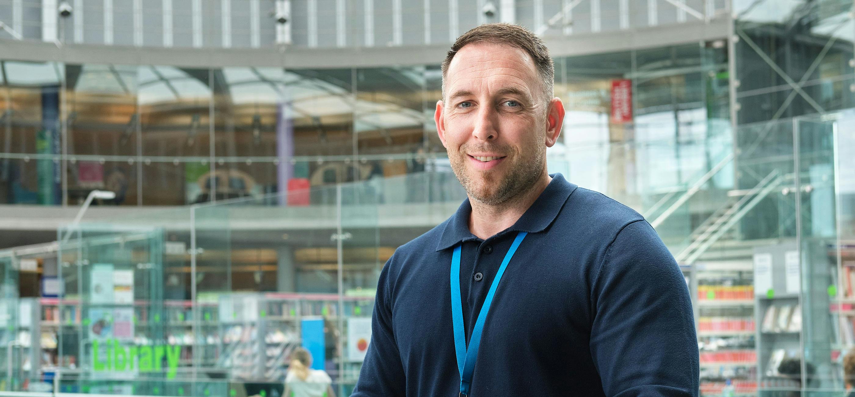 A member of The Forum Customer Service team with blue polar neck shirt