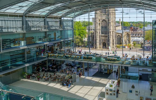 A view looking down on The Forum, Norwich. A modern landmark building with glass frontage looking out to St Peter Mancroft Church.