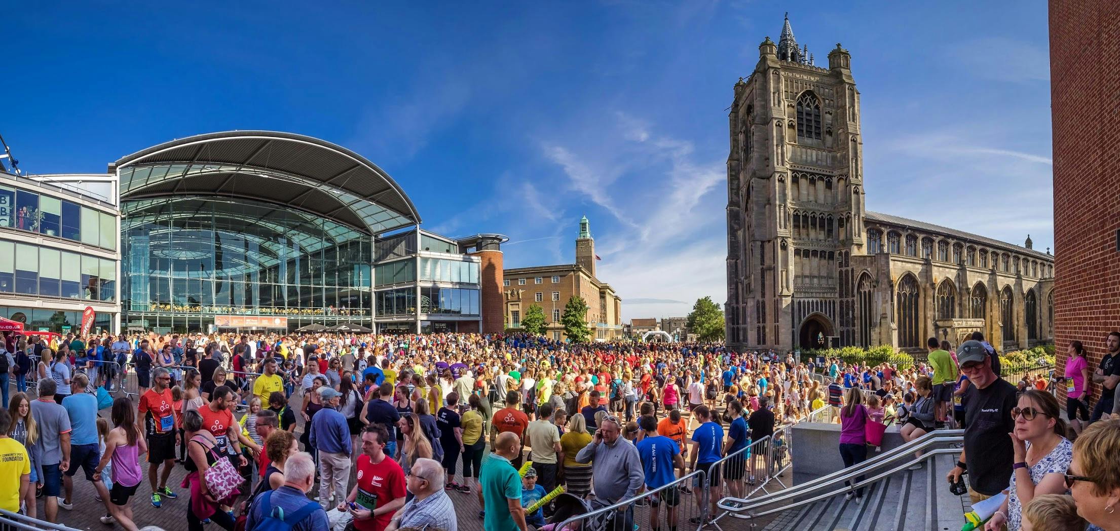 A crowd of people outside The Forum on a sunny day for Run Norwich.