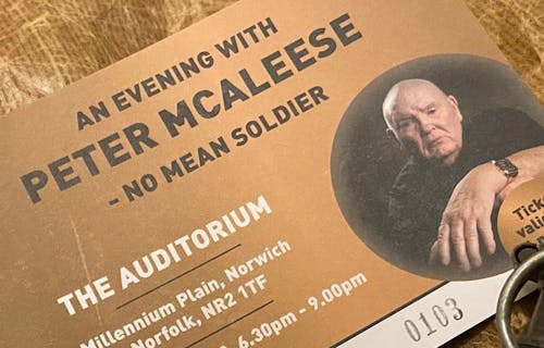 A close up of a ticket for An Evening with Peter McAleese