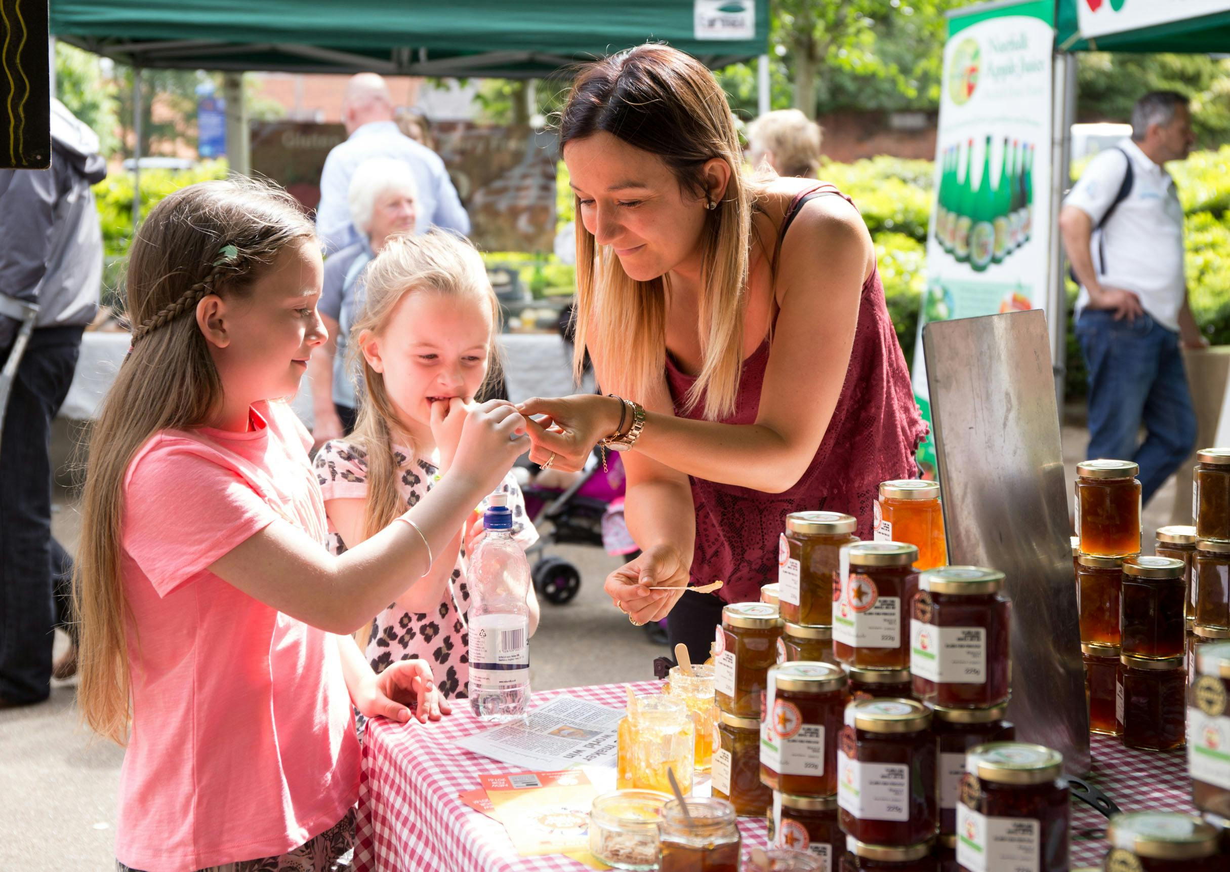 Family try chutneys at a food stall