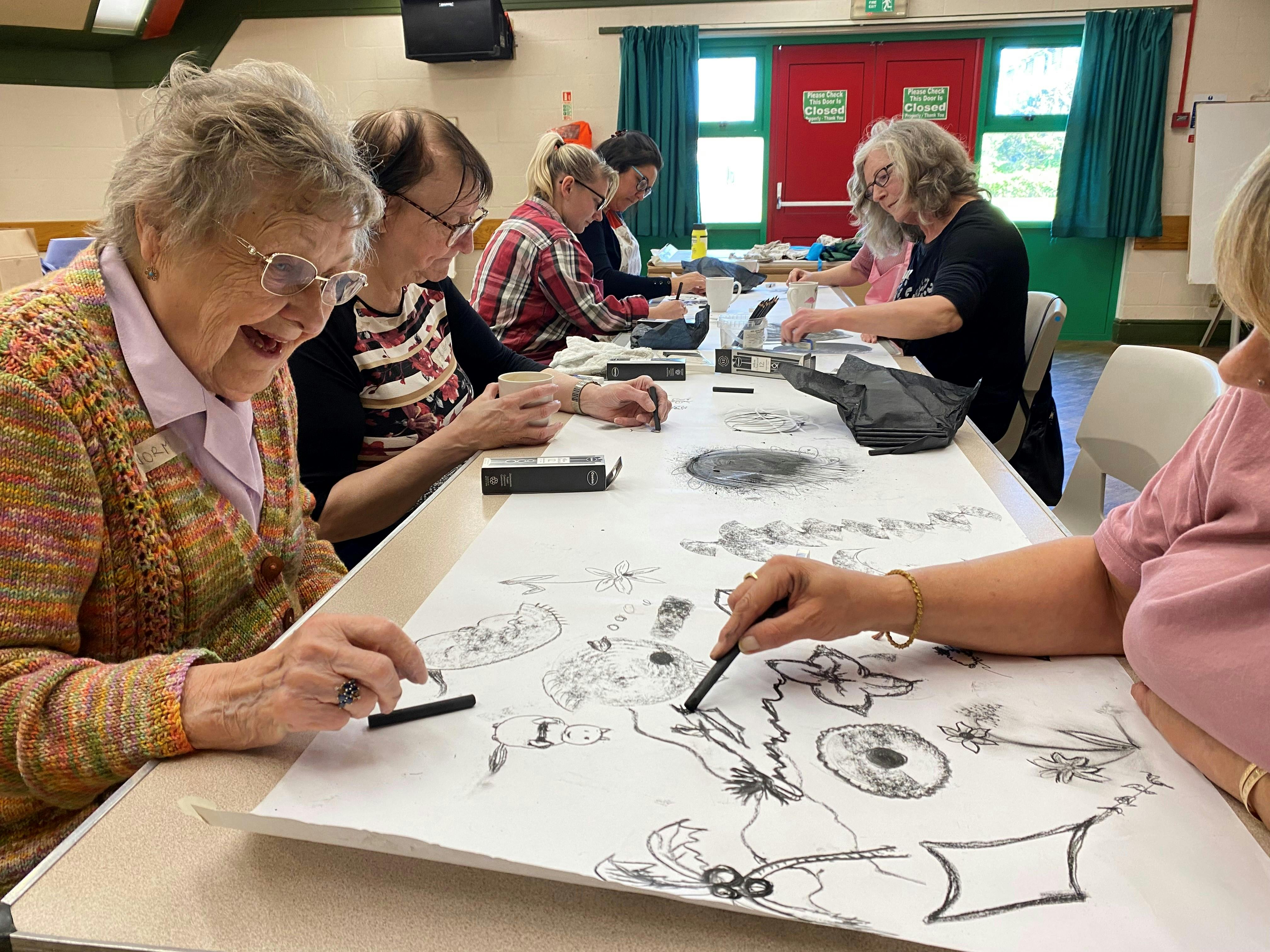 women using charcoal on paper