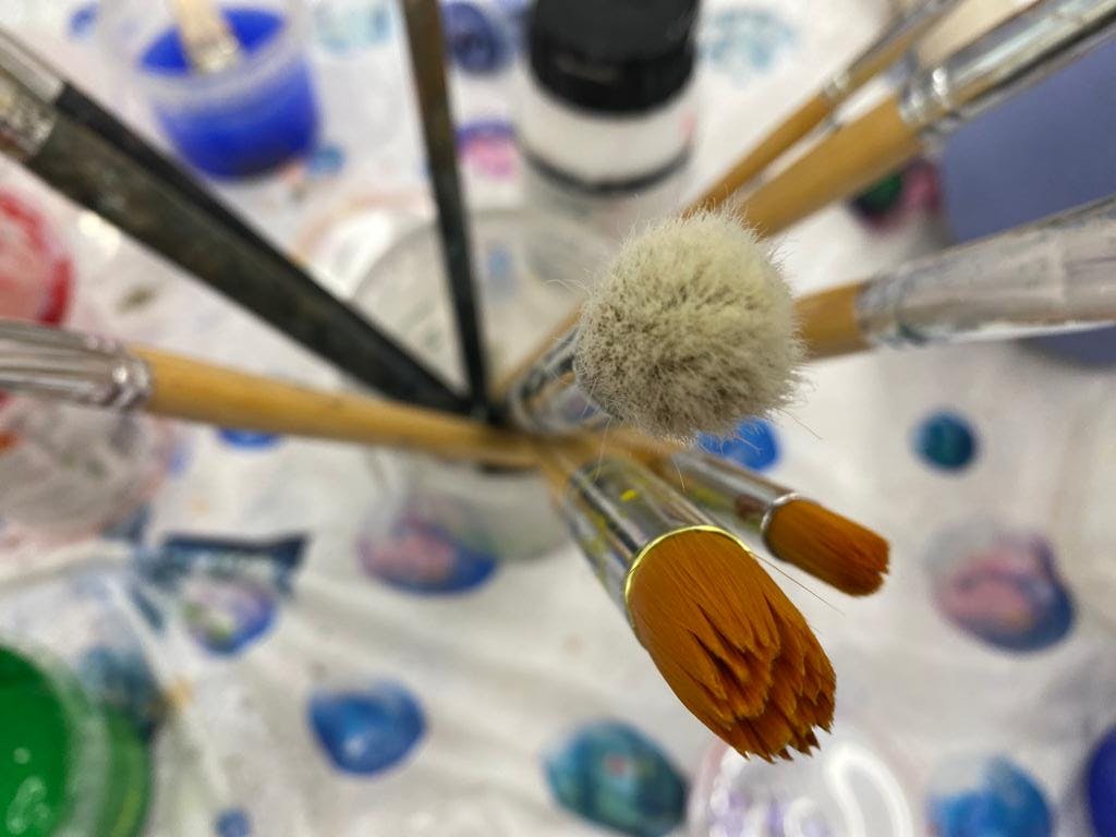 paint brushes in a jar viewed from above