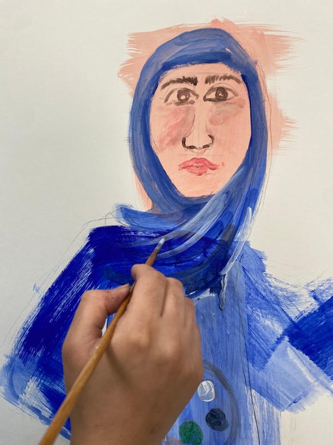 Woman's hand painting a portrait
