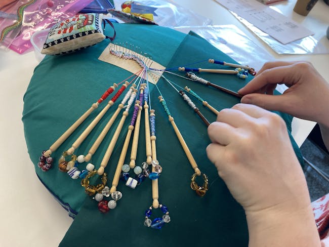 Close up of hands making lace.