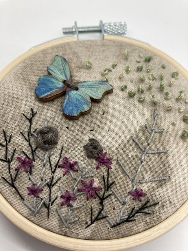 Embroidery of flowers and butterfly in hoop