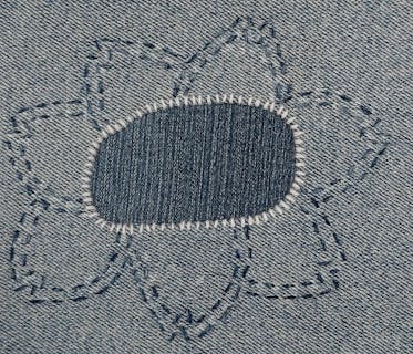 a stitched repair decorated with a flower shape