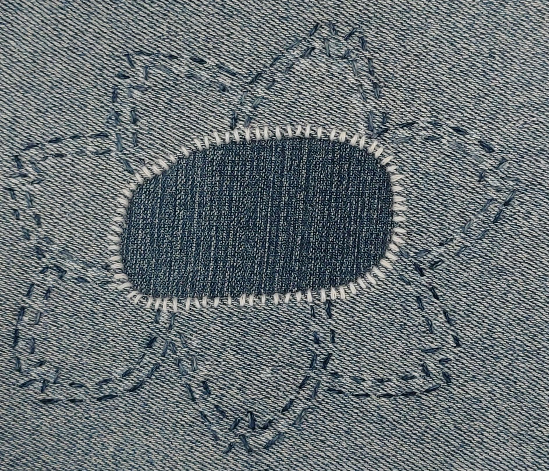 visibl~1.jpg a stitched repair decorated with a flower shape