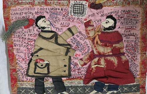 Quilt with two people and writing on