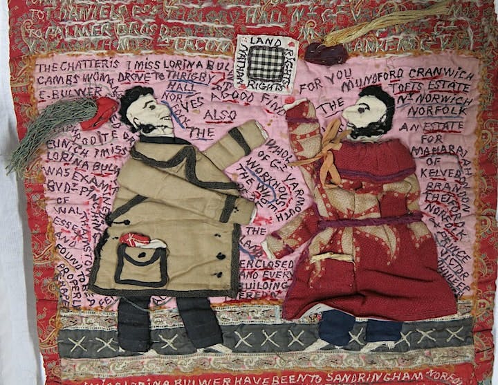 Quilt with two people and writing on