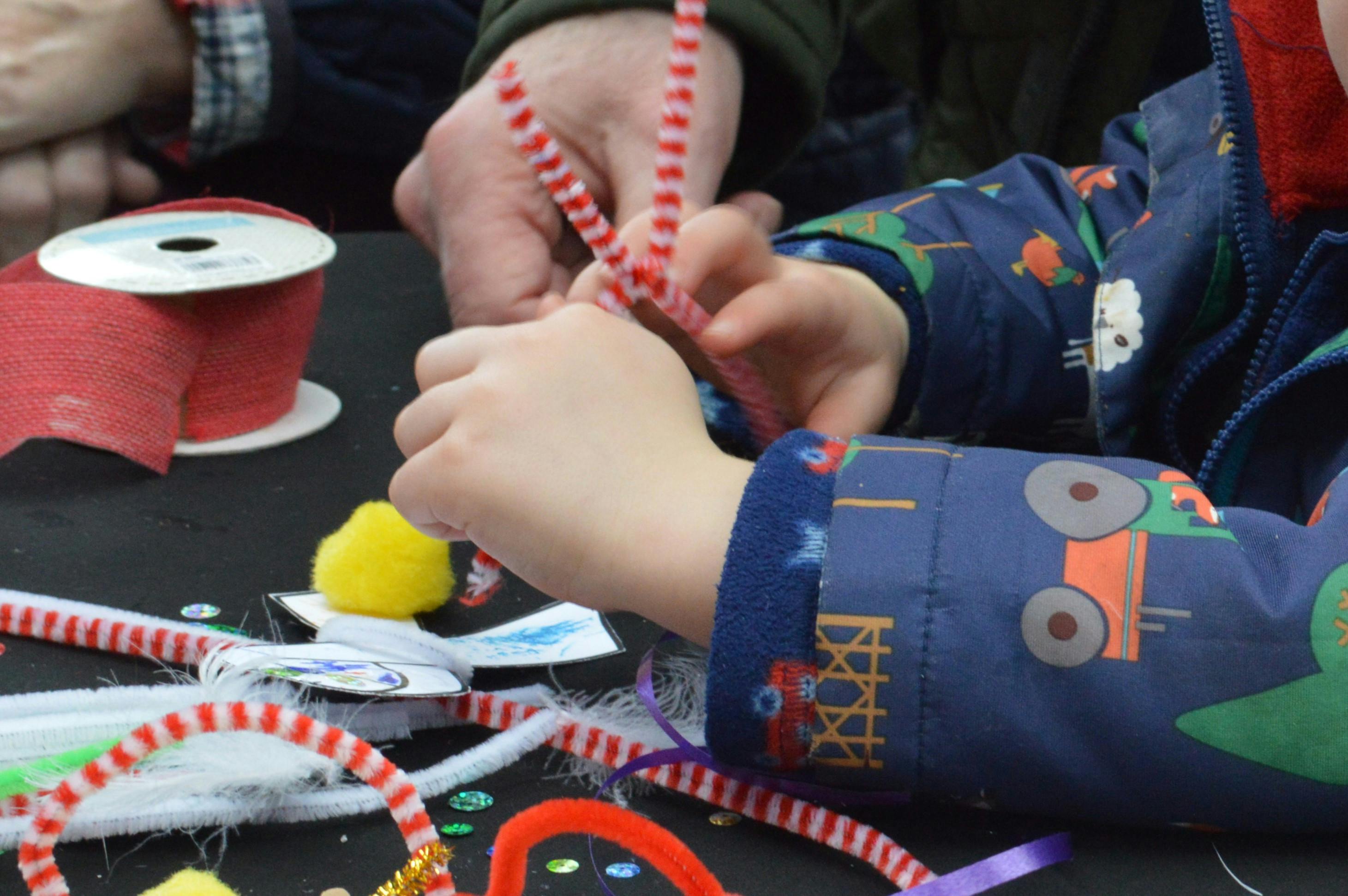 Child's hands using craft supplies