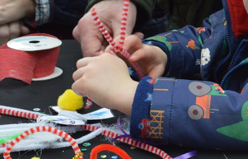 Child's hands using craft supplies