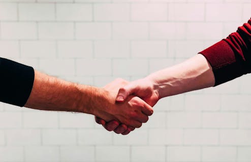 close up of a hand shake between two men