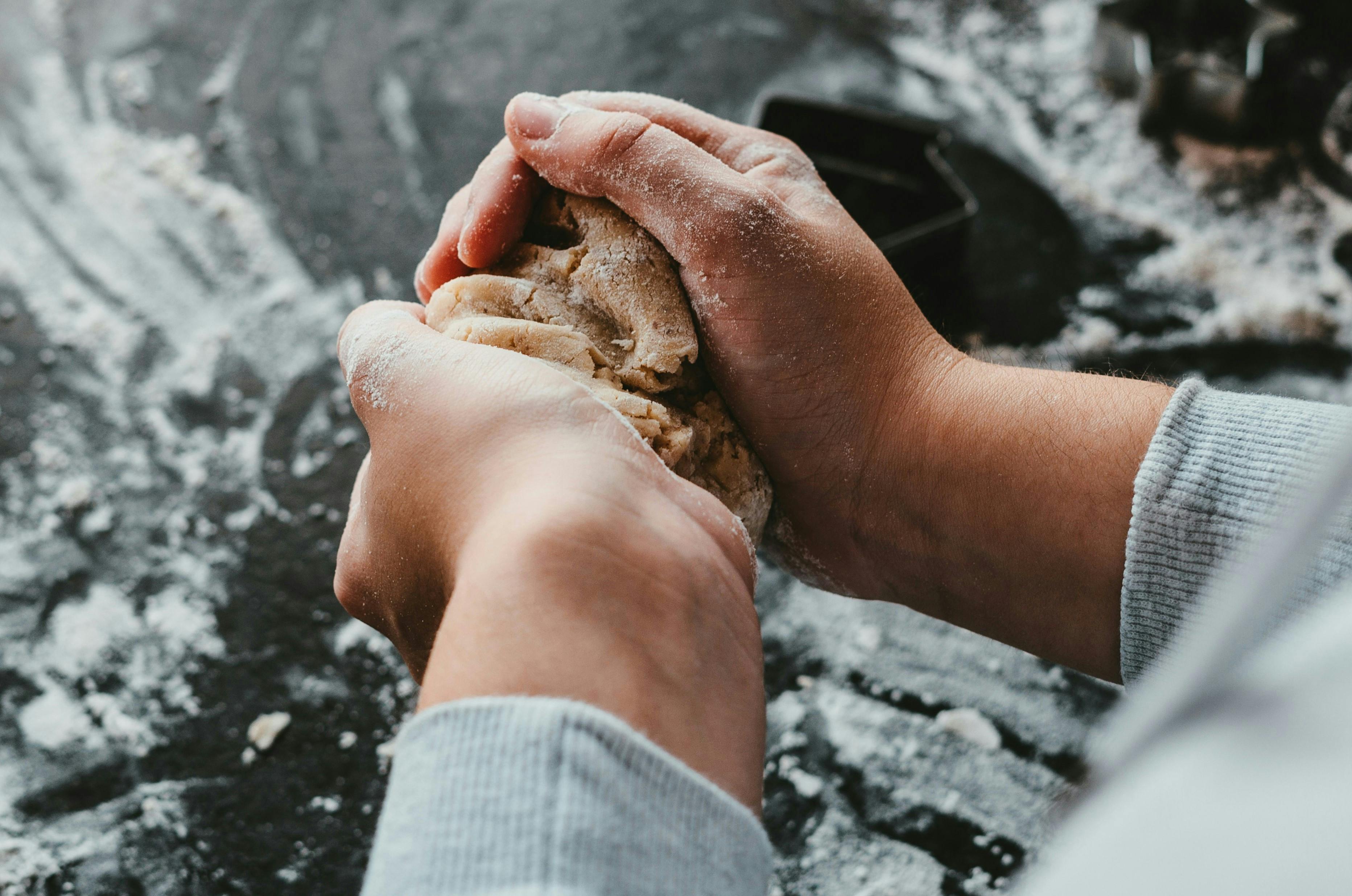 man's hands holding pastry