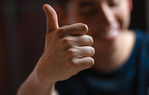 Man's hand giving a thumbs up