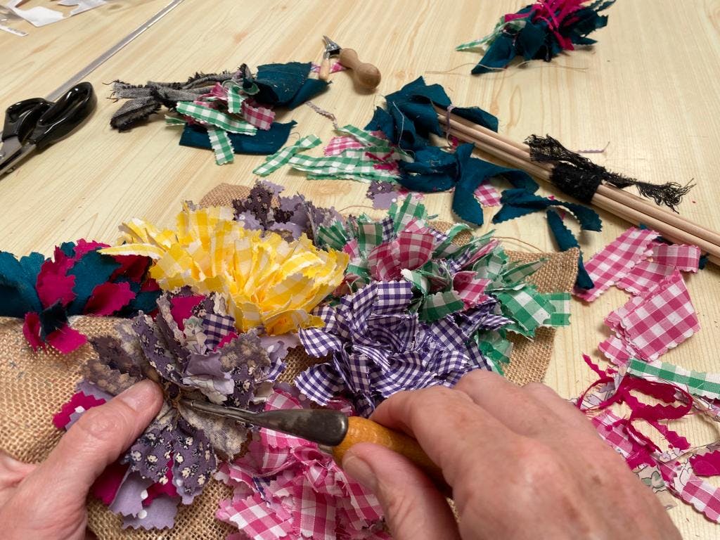 scraps of material being woven into canvas