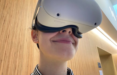 young face wearing white VR head set