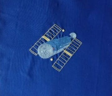Embroidered satellite on fabric
