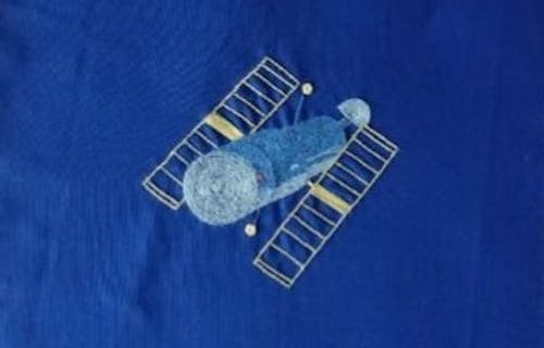 Embroidered satellite on fabric