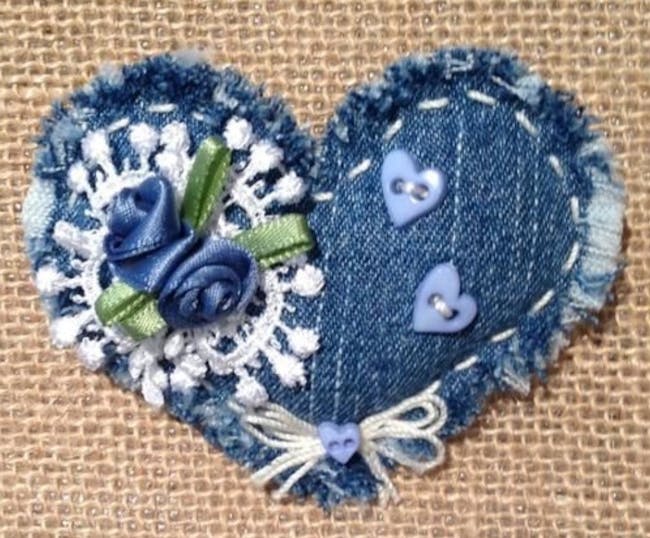 a blue denim hear shape with blue and white stiches and embellishments