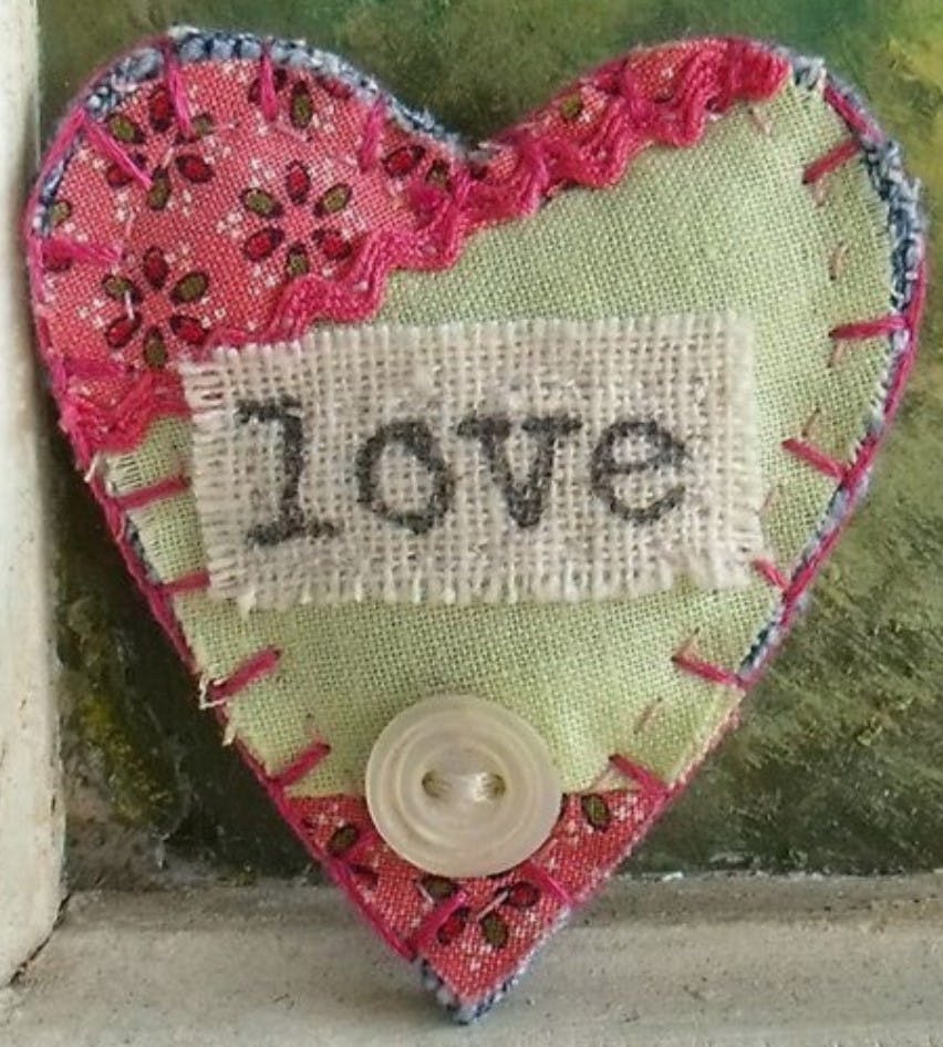 textile heart with the word love printed on fabric