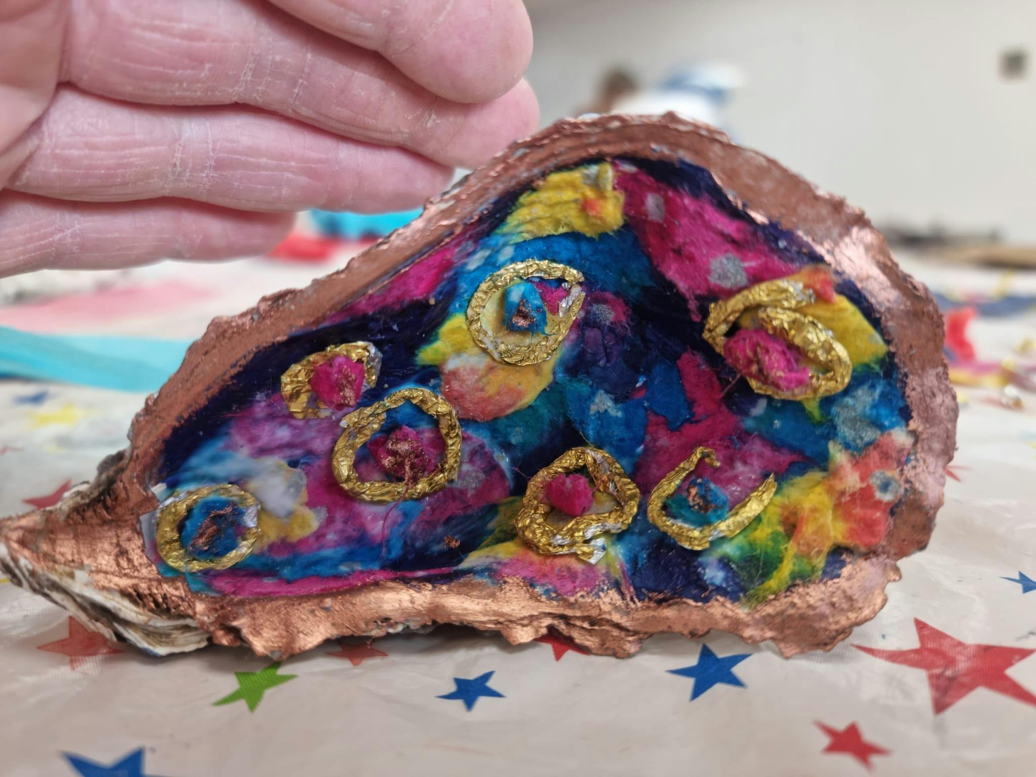 oyster shell decorated with fabric and thread