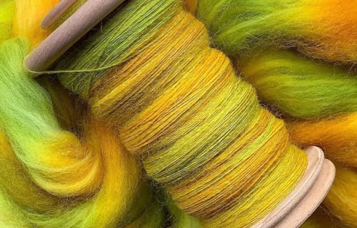 Bobbins with green and yellow yarn