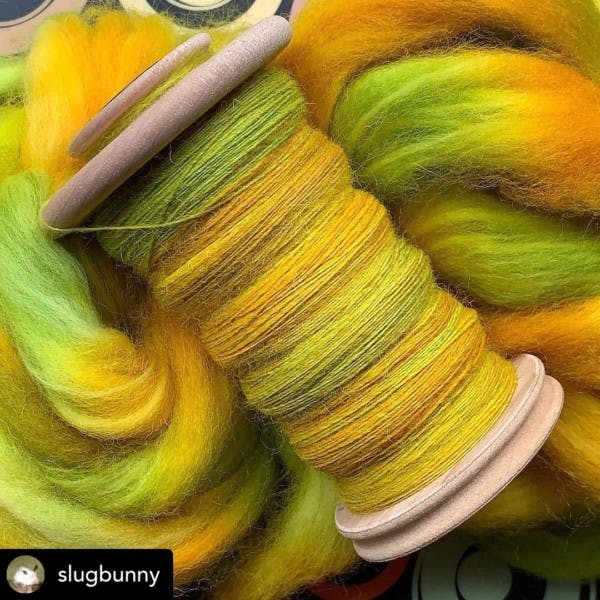 Bobbins with green and yellow yarn