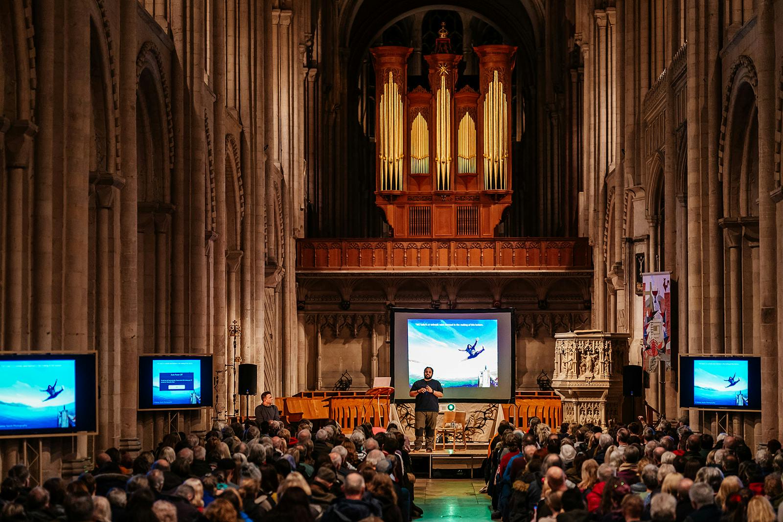 Hamza Yassin on stage to a packed audience at Norwich Cathedral