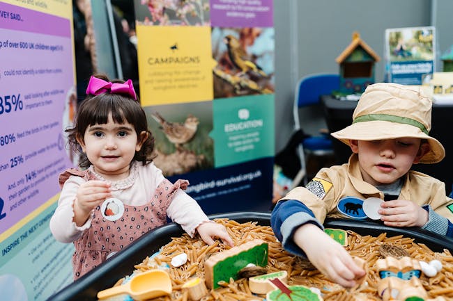 Two small children take part in a pasta shapes activity in The Explorium