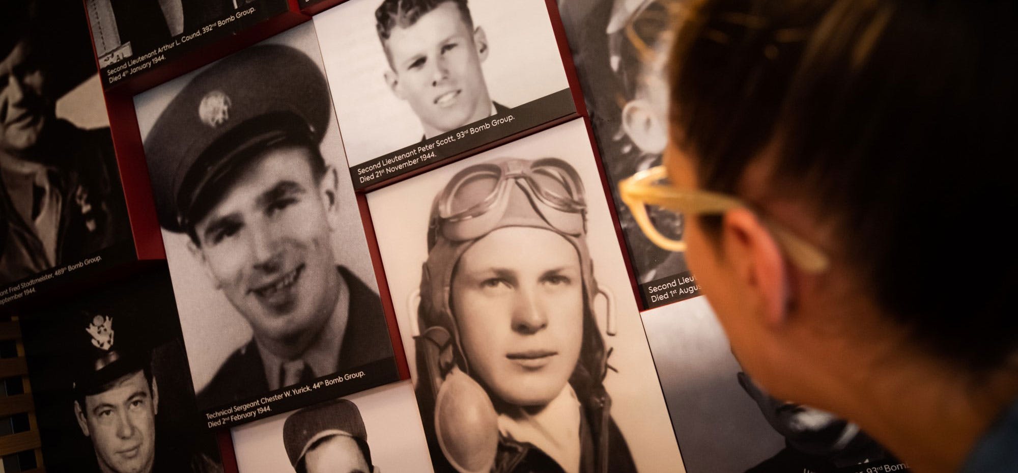 A display of black and white photographs honoring members of the Second Air Division.