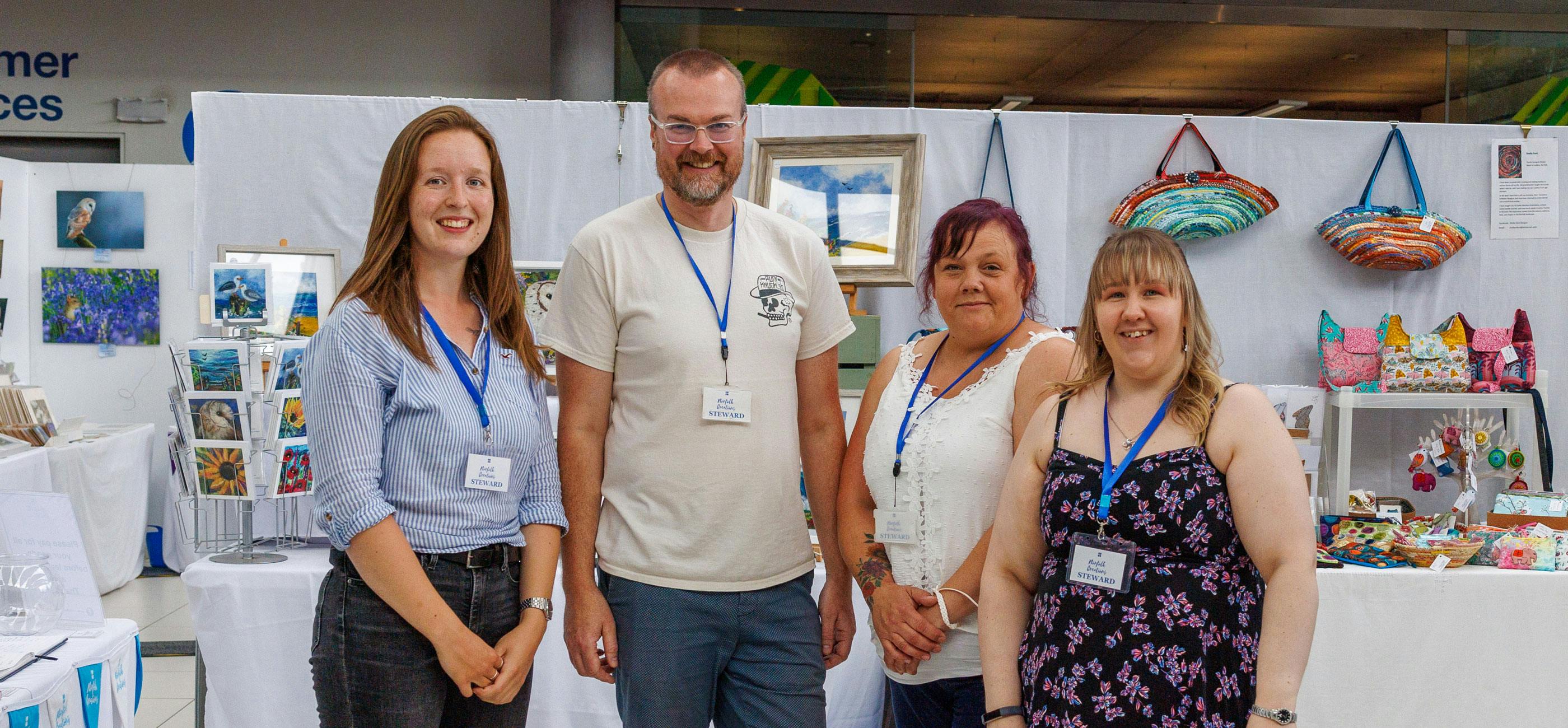 The Norfolk Creations team in front of their colourful craft market.