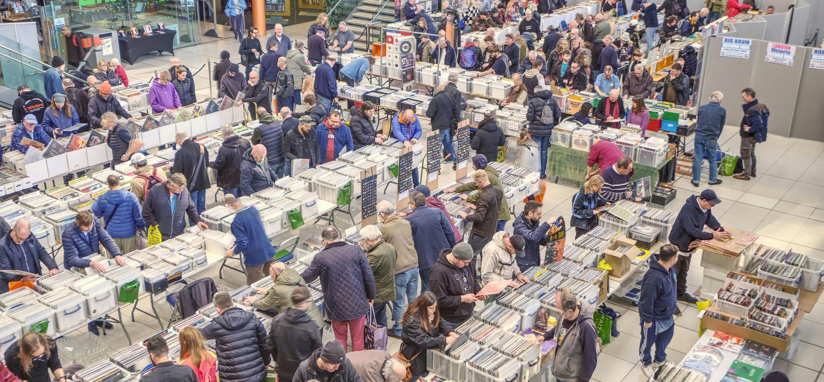 Norwich Record Fair at The Forum, with people browsing lots of containers of vinyl records.