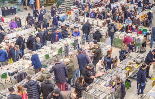 Norwich Record Fair at The Forum, with people browsing lots of containers of vinyl records.