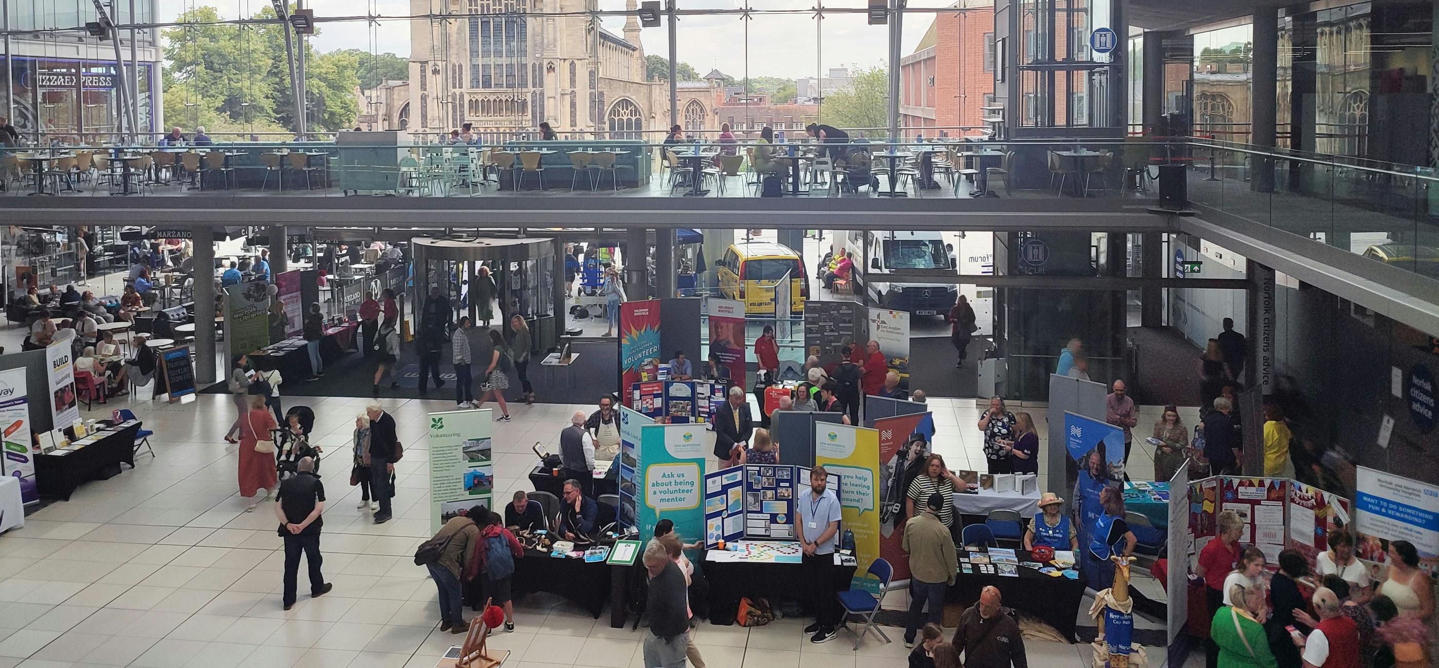 volunteer-extravaganza.jpg A busy volunteering fair with lots of stalls.
