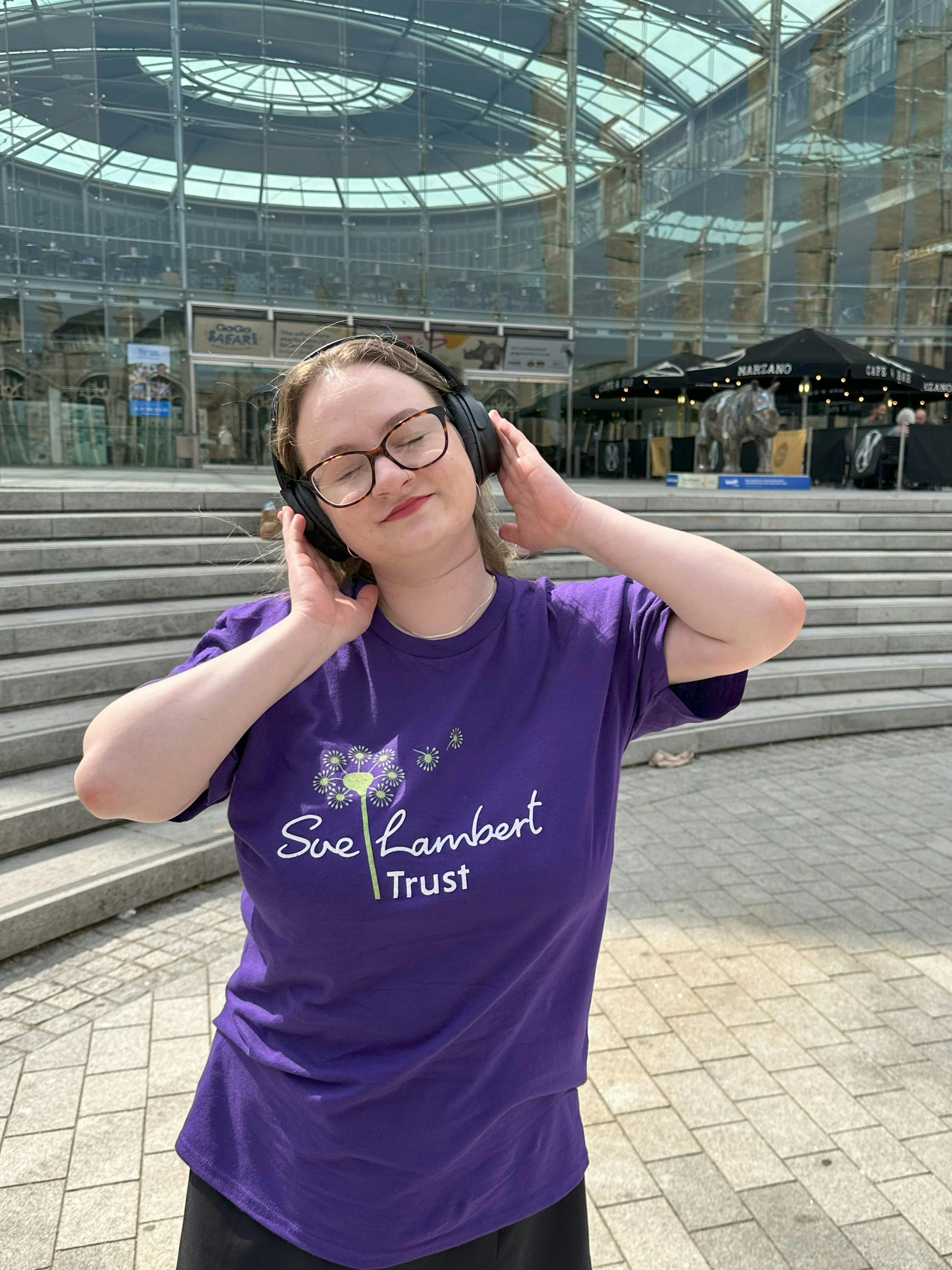 Woman wearing headphones with her eyes closed enjoying the music.