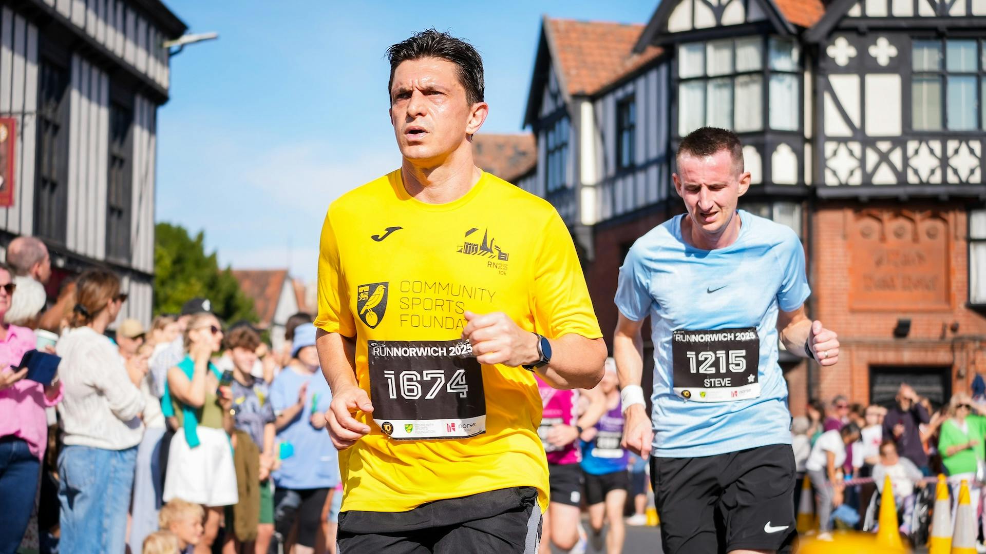 Two men running on a sunny day.