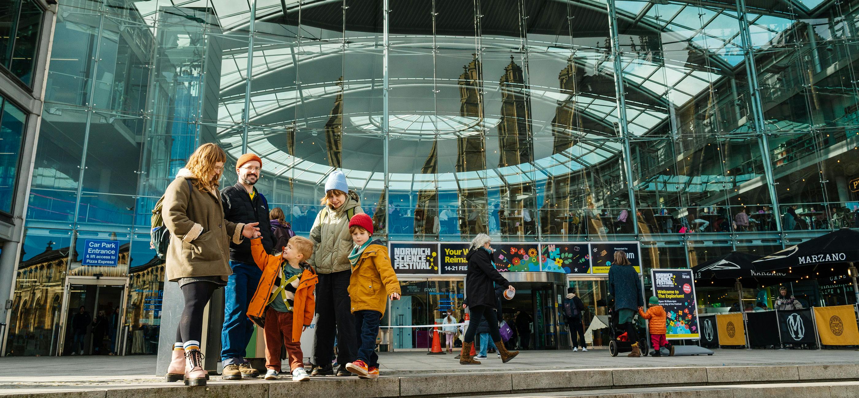 A family smile outside The Forum