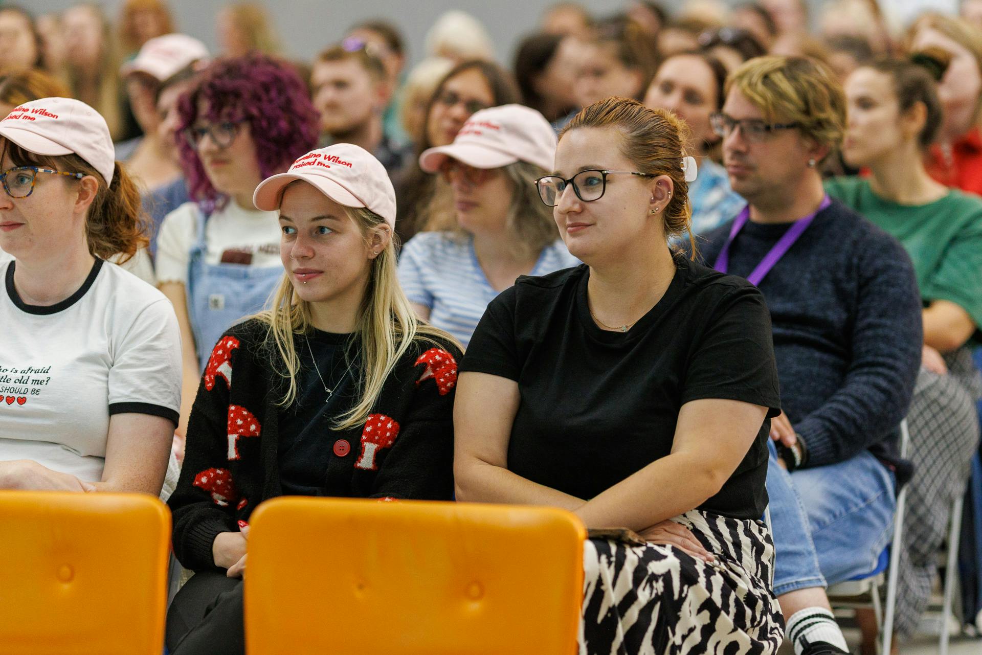 An engaged audience, some of them are wearing Jacqueline Wilson hats