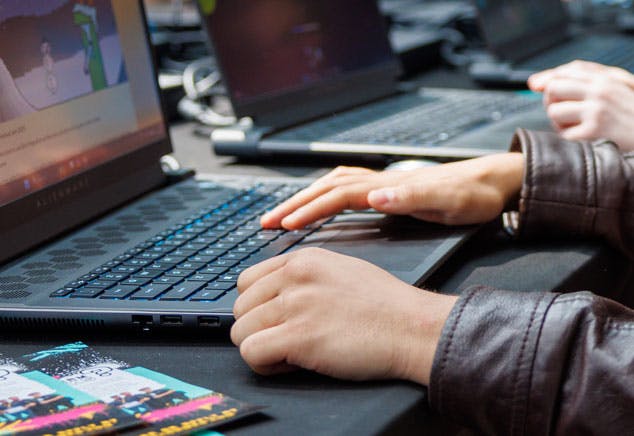 Close up of hand typing on a laptop