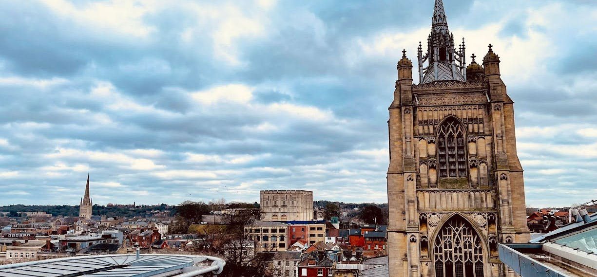 Norwich city skyline with church spired and Norwich castle