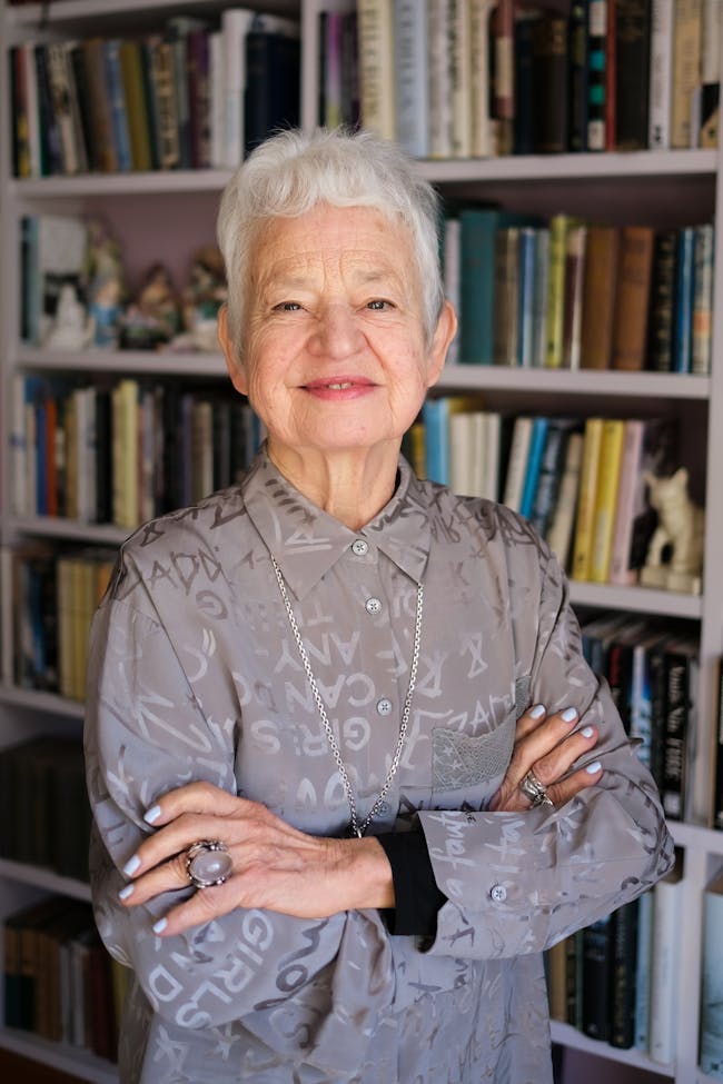 Jacqueline Wilson standing in front of a bookcase