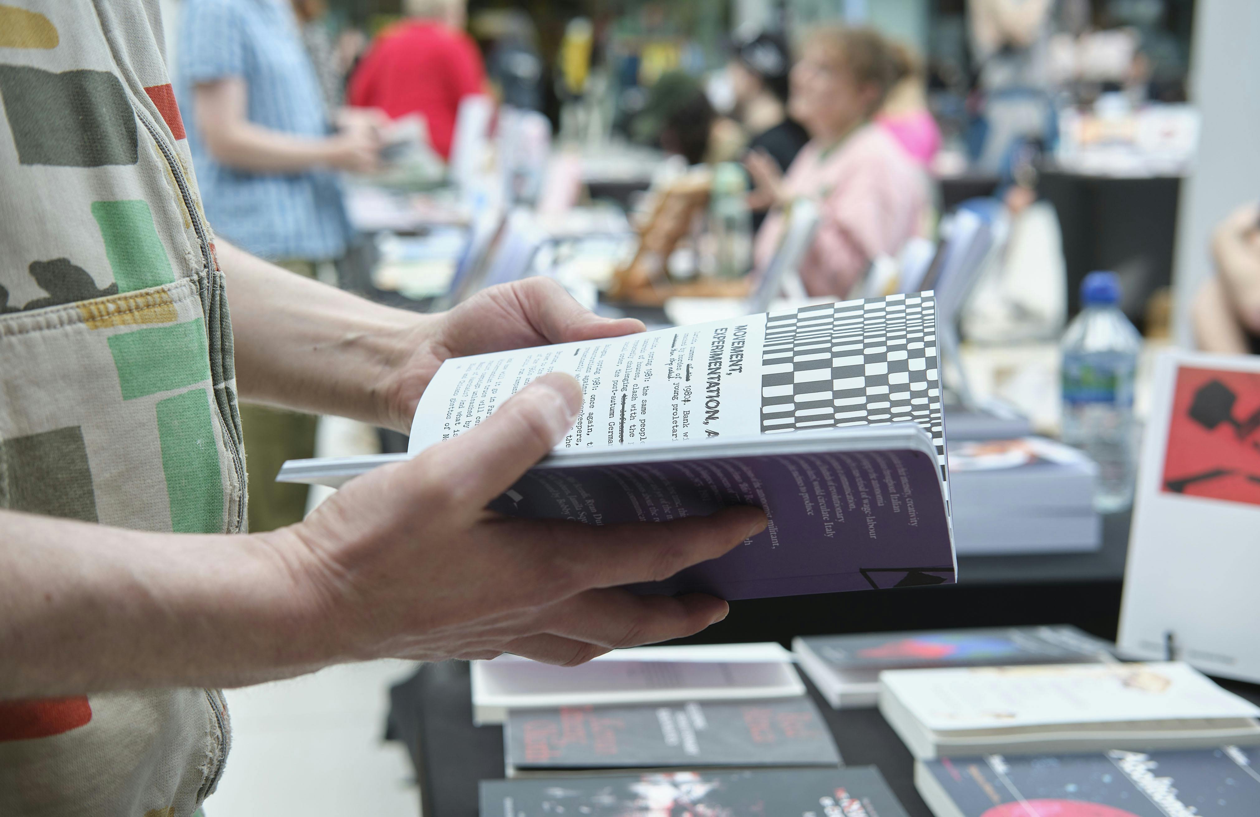 A pair of hands flicking through a book.