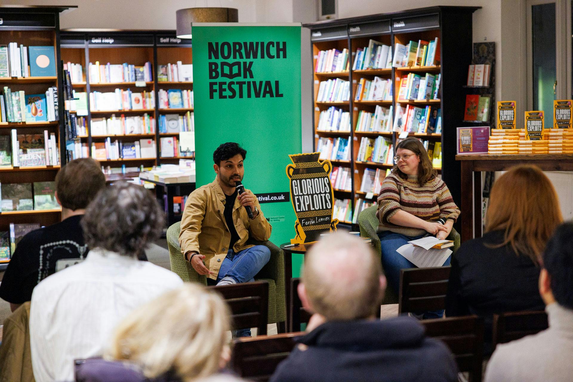 Author Ferdia Lennon talks to a crowd in a bookshop