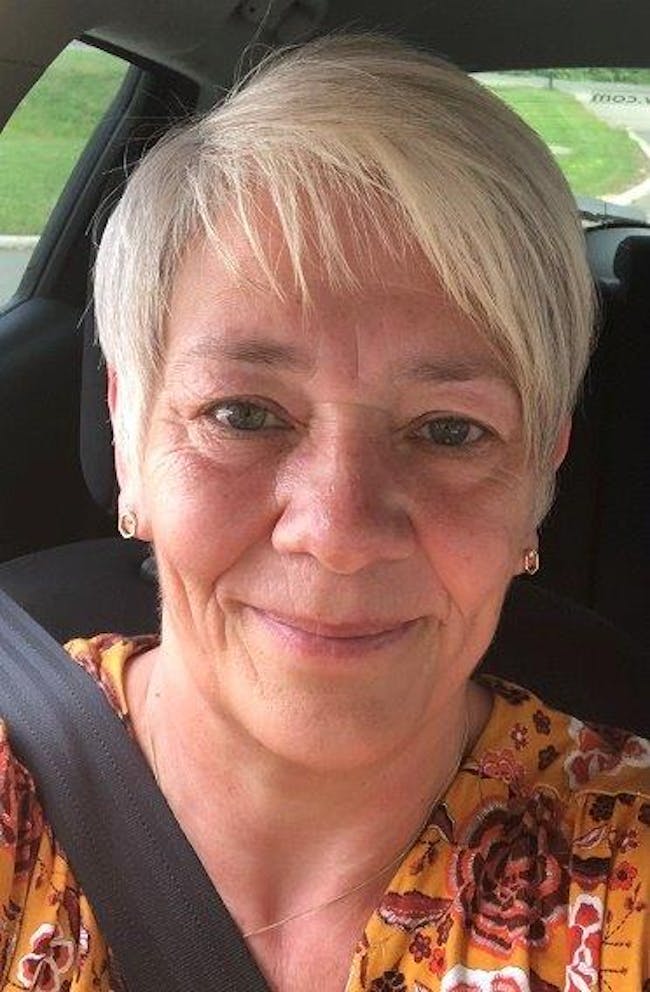 A smiling woman with short blonde hair.