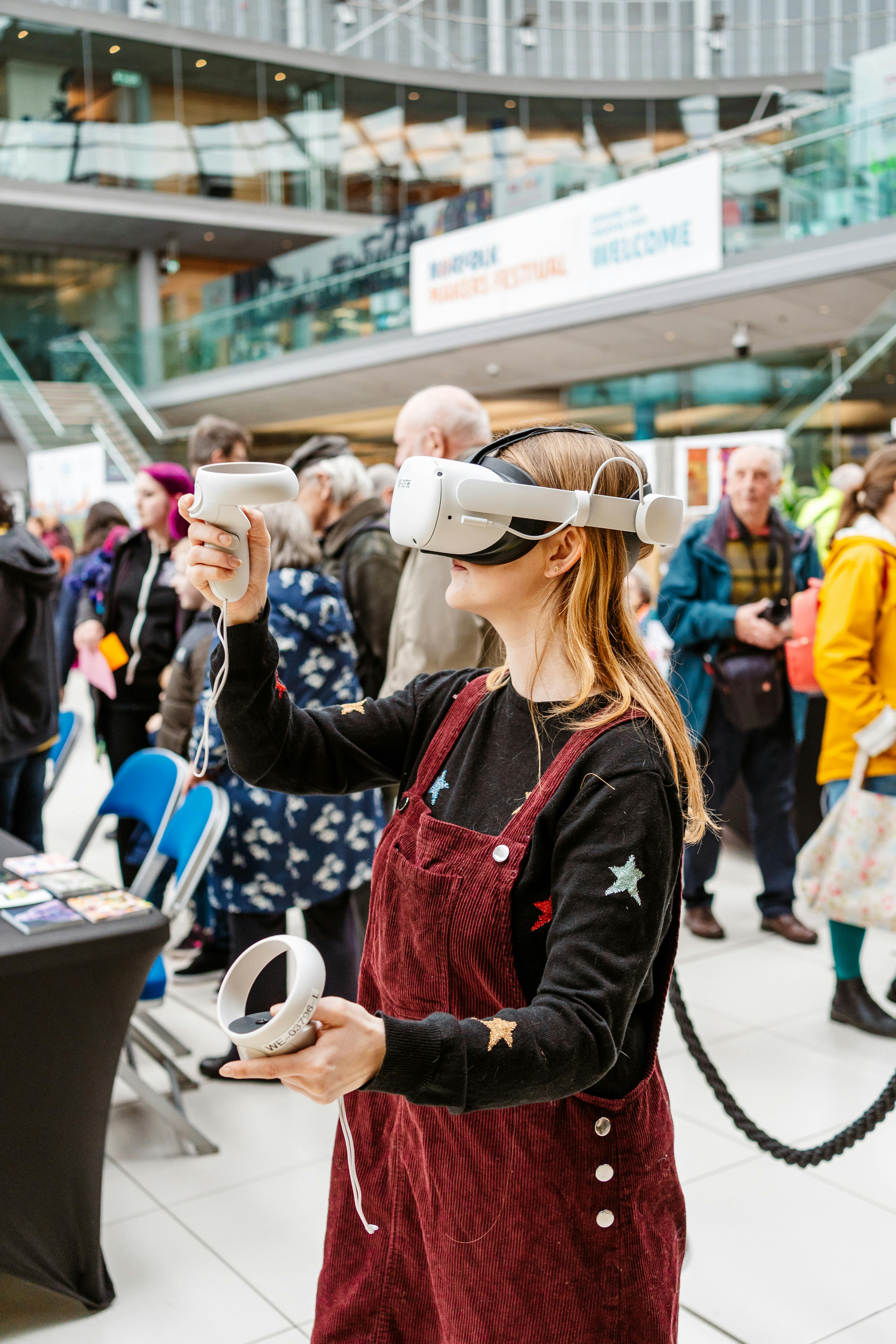 A young woman with long strawberry blonde hair wearing a VR headset