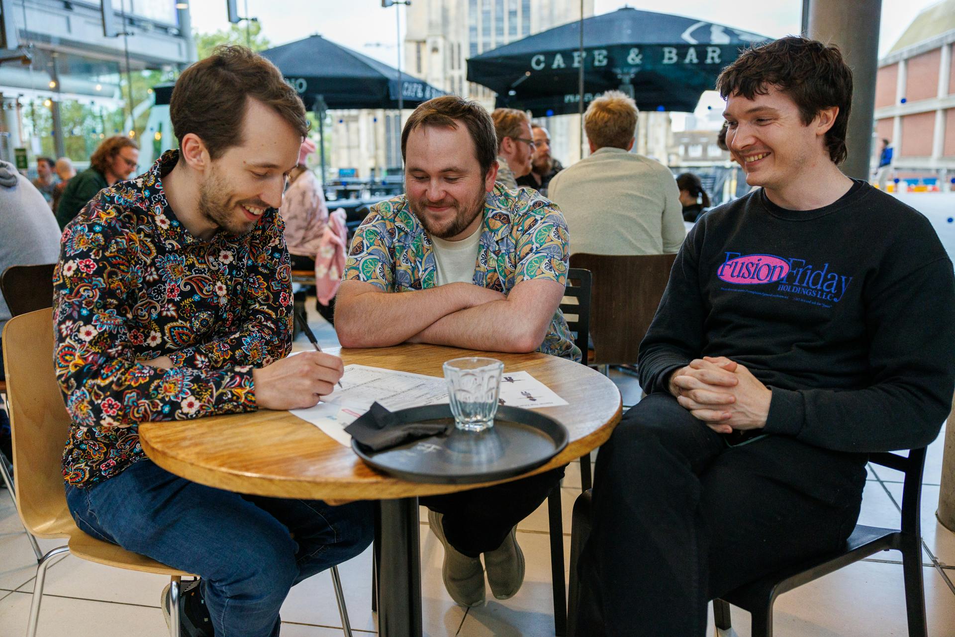 Three men sitting at a table